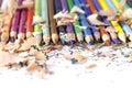 Lot of colorful pencils frame with sawdust and shavings on white Royalty Free Stock Photo