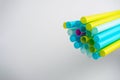 A lot of colorful plastic tubes on a white background. Selective focus, copy space Royalty Free Stock Photo