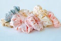 Lot of Colorful silk Scrunchies on white. Flat lay Hairdressing tools and accessories. Hair Scrunchies, Elastic