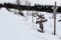 Lot of confusing signs where a snowmobile trail cross the road, Royalty Free Stock Photo