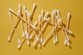 Lot of cotton swabs, ear sticks are scattered on yellow background. Beauty and health. Facial care. Flatley. MOCKUP. Royalty Free Stock Photo