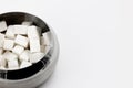a lot of cubes of white refined sugar in a metal sugar bowl top view close-up Royalty Free Stock Photo