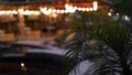 A lot of decorative vintage garland light bulbs in front of a pub restaurant terrace, blurred focus, romantic setting on Royalty Free Stock Photo