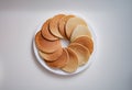 Lot of delicious appetizing pancakes lying on white plate in circle top view