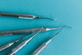 Lot of dental periodontal scalers on blue background.