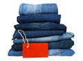 Lot of different blue jeans and red label on white background Royalty Free Stock Photo
