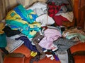 A lot of different clothes on the couch. A mess of clothes. Ironed clothes Royalty Free Stock Photo