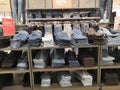 Lot of different color striped long sleeve,blue jeans shirts are neatly stacked in a row on the store shelves