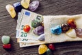 Lot of different color and type semi precious stones with euro money bank notes.