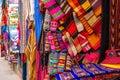 A lot of different colorful fabric coverlets on the souvenir store in Bolivia Royalty Free Stock Photo