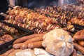 A lot of different meats and sausages are on the counter and grilled, during the street festival Royalty Free Stock Photo