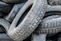 A lot of different old, dirty worn out car tires in a landfill