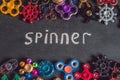 A lot of different spinners on a black background And the inscription spinner Royalty Free Stock Photo
