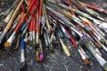 A lot dirty artist paint brushes in a bucket