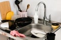 A lot of dirty dishes in the white sink in the kitchen Royalty Free Stock Photo