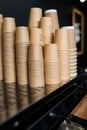 Lot of drinking paper coffee cups in piles. Stack of disposable coffee cup, selective focus.