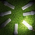 Lot of Energy-saving lamp in green grass backround