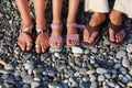 Lot of feet on the stones. Family with girl Royalty Free Stock Photo