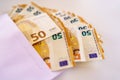 A lot of fifty euro banknotes stuffed into a white paper envelope Royalty Free Stock Photo
