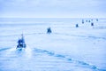 A lot of fishing boats heading out into the blue sea in the evening Royalty Free Stock Photo