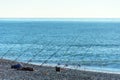 Lot of fishing rods lined up on the seashore. Large-scale fishing during the fish spawning season Royalty Free Stock Photo