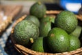 Lot of fresh avocados in a weaved basket with a blurred background Royalty Free Stock Photo