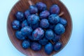 Fresh ripe plums on the wooden bowl Royalty Free Stock Photo