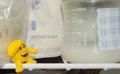 Lot of frozzen breast milk in storage bags stored in the freezer and baby bottle with fresh expresed breastmilk