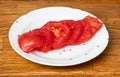 Lot of fruit flies Drosophila melanogaster eating of slices of tomatoes. Royalty Free Stock Photo