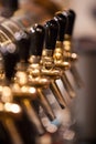 A lot of Golden beer taps at the bar Royalty Free Stock Photo