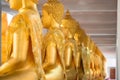 A Lot of Golden Statue of Buddha sitting meditated  in the row at Thailand Temple Royalty Free Stock Photo