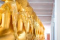 A Lot of Golden Statue of Buddha sitting meditated  in the row at Thailand Temple Royalty Free Stock Photo