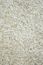 A lot of gray little raw rice grains are lying on the table. The view from the top. Close up. Royalty Free Stock Photo