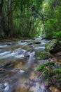 Lot of green stones in the middle of the water from beautiful waterfall Royalty Free Stock Photo