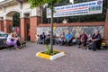 A lot of happy Turkish Romany Gypsy citizens and family sitting on public benches and looking at camera and posing altogether