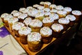 A lot of homemade Easter cakes with white icing and colorful confectionery toppings.