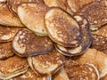 A lot of homemade small thick pancakes close-up. Top view. Traditional russian sweet dessert.