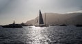 A lot of huge sail yachts and motor boats in port of Monaco at sunset, mountains are on background, megayachts are