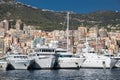 A lot of huge yachts are in port of Monaco at sunny day, megayachts are moored in marina, is a yacht show, Monte Carlo