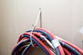 A lot of Internet, Ethernet UTP cables and electrical cables without cable trays are temporary installed on the walls Royalty Free Stock Photo