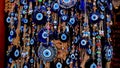 A lot of key rings with a blue eye, amulets, beads from the evil eye in the souvenir shop of the Turkish city Royalty Free Stock Photo