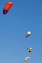 A lot of kiteboarding kites in the blue sky