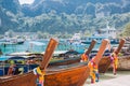 A lot of long tail boats on tropical beach. Moored in the port on the asian island Royalty Free Stock Photo