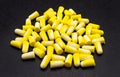A lot of lying earplugs, for protection against noise in yellow and white, isolated on a black background. Royalty Free Stock Photo