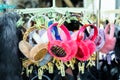 Lot of many multicolored bright fluffy warm winter fur earphones and gloves hanged on rack at store display for sale. Cute cold Royalty Free Stock Photo