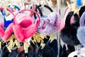 Lot of many multicolored bright fluffy warm winter fur earphones and gloves hanged on rack at store display for sale. Cute cold Royalty Free Stock Photo