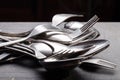 Lot of metal cutlery on a black background. Selective focus. Shallow depth of field Royalty Free Stock Photo