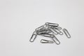 A lot of metal paperclips isolated on a white background, a set of office supplies Royalty Free Stock Photo