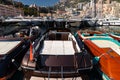 A lot of motor boats in rows are in port of Monaco at sunny day, Monte Carlo, mountain is on background, colourful