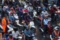 Lot of motorcycles waiting for traffic signal in Bangkok city in the evening after office rush hour Royalty Free Stock Photo